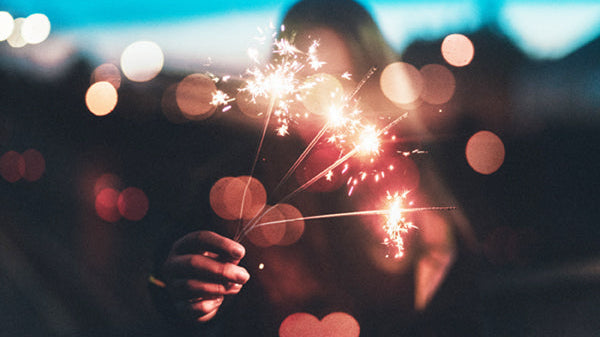 girl lighting a sparkler, teach DEI at home